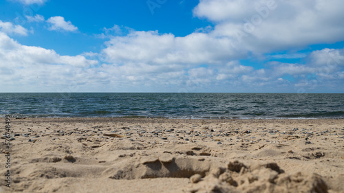 Fototapeta Naklejka Na Ścianę i Meble -  Close-up of the sand on a beach with the sea in the background