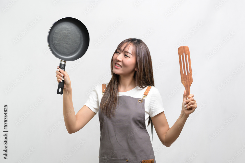 Portrait of young asian woman wearing apron over white background studio, cooking and entrepreneur concept. Portrait of young asian woman wearing apron over white background studio, cooking and entrepreneur concept.