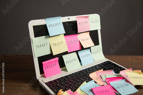 Laptop computer with colorful sticky notes. Business