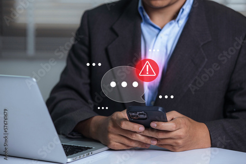 Businessman using smartphone with new message electronic email hacking and spam warning symbol. cyber attack network, virus, spyware, Cyber security and cybercrime. photo