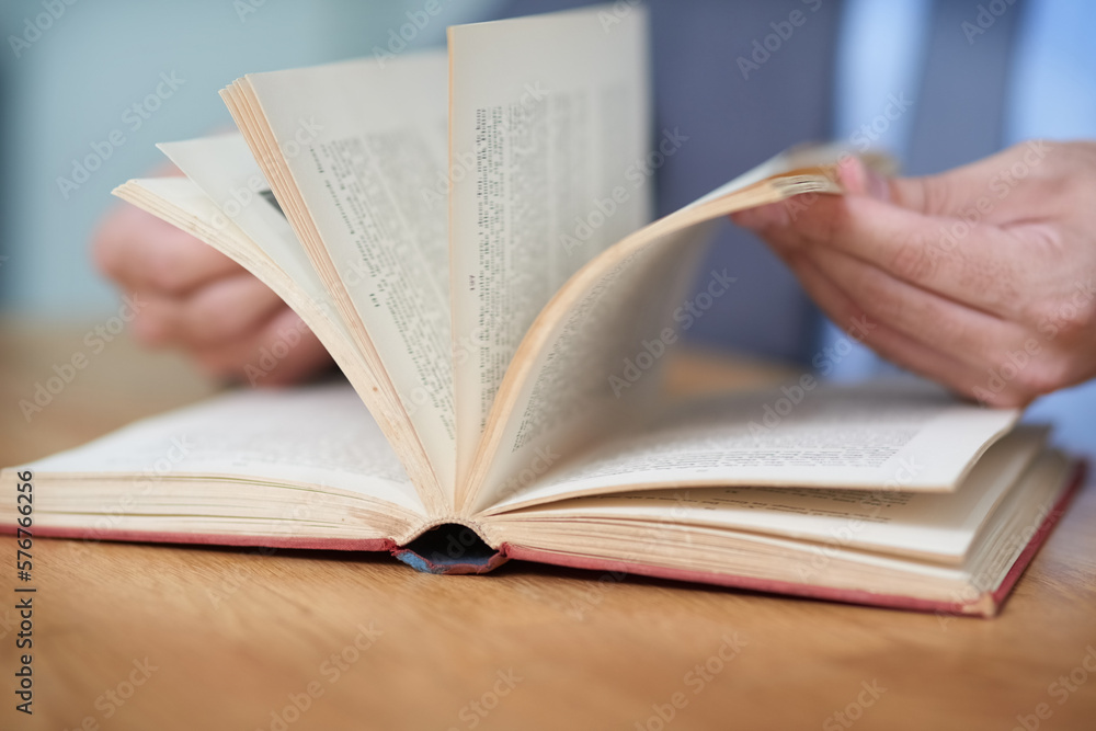 Make your success story a page turner. Cropped shot of an unidentifiable man reading a book. Make your success story a page turner. Cropped shot of an unidentifiable man reading a book.