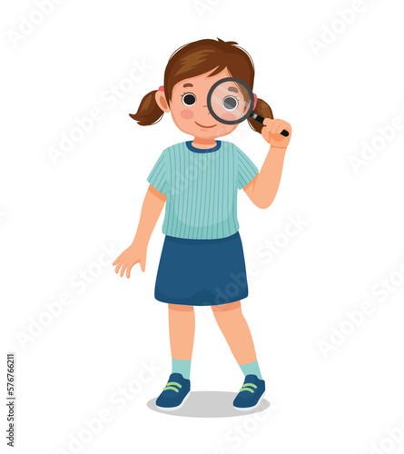 Cute little girl looking through magnifying glass