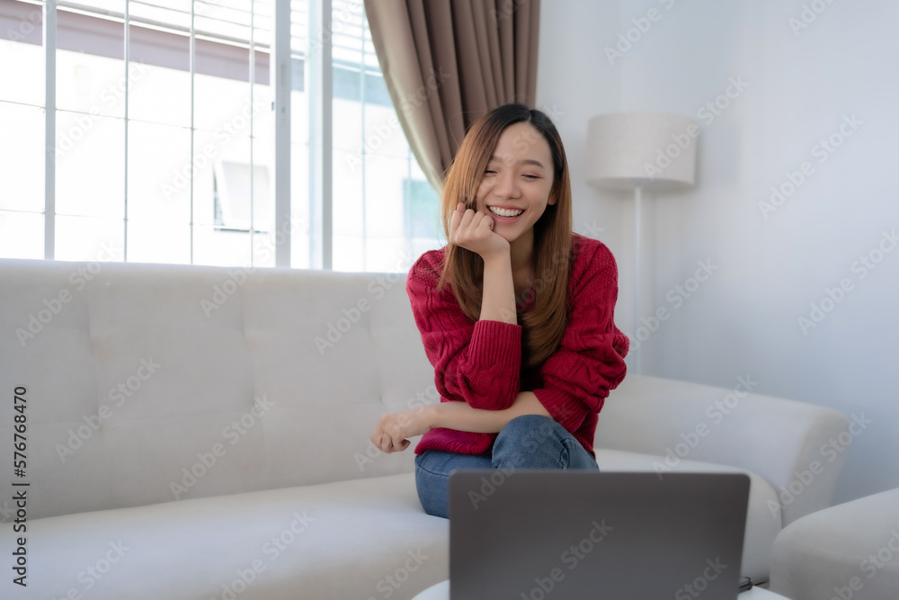 Happy young Asian business woman successful excited raised hand rejoicing with laptop at home. Happy young Asian business woman successful excited raised hand rejoicing with laptop at home.