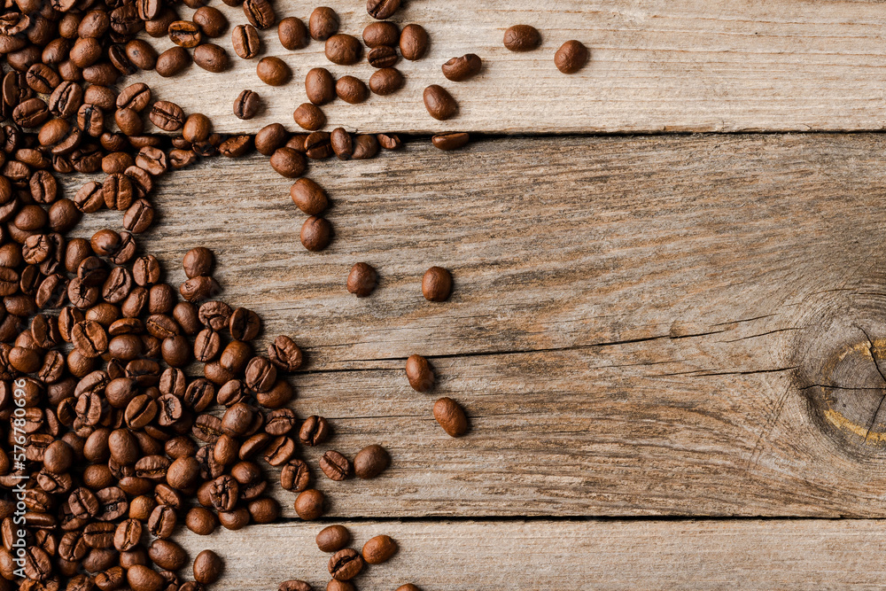 Coffee beans on an old wooden table. Coffee beans on an old wooden table.