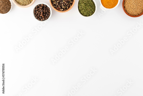 Overhead shot of seasonings in bowls isolated on white background with copyspace