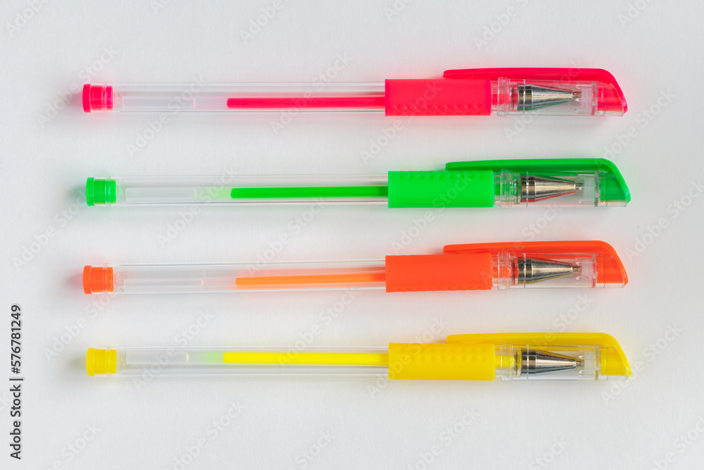 Colorful gel neon pens on white background