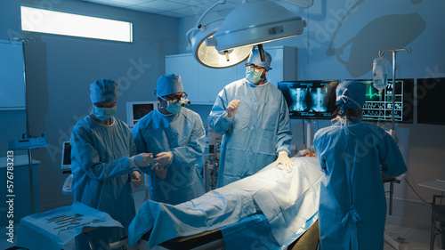 The medical team discussed the surgical options with the patient before proceeding with the operation. Surgeons team operating a patient in the operating room at the hospital