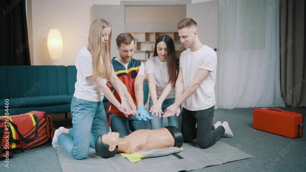 First aid resuscitation, CPR training. Students study in front of a dummy First aid resuscitation, CPR training. Students study in front of a dummy