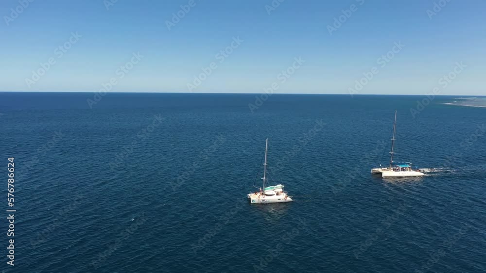 Aerial view of sailing boats along the shoreline in Flic en Flac on Mauritius Island. Aerial view of sailing boats along the shoreline in Flic en Flac on Mauritius Island.
