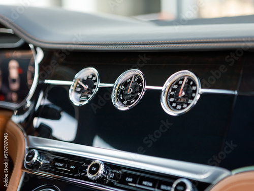 mechanical clock and other gauges on luxury car dashboard © AvokadoStudio