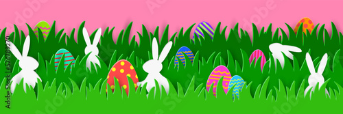 Easter egg hunt banner with rabbits and coloured eggs hidden in the grass. Paper cut style. Panoramic header. Vector illustration