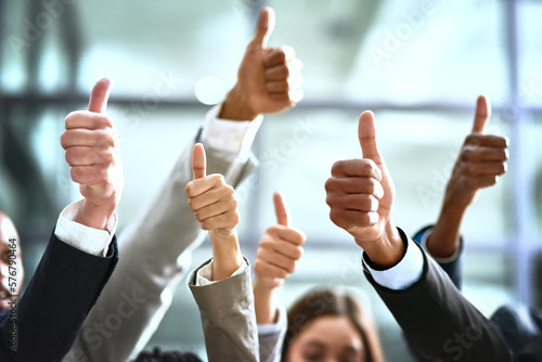 Need we say more. Cropped shot of a group of businesspeople giving thumbs up in a modern office.
