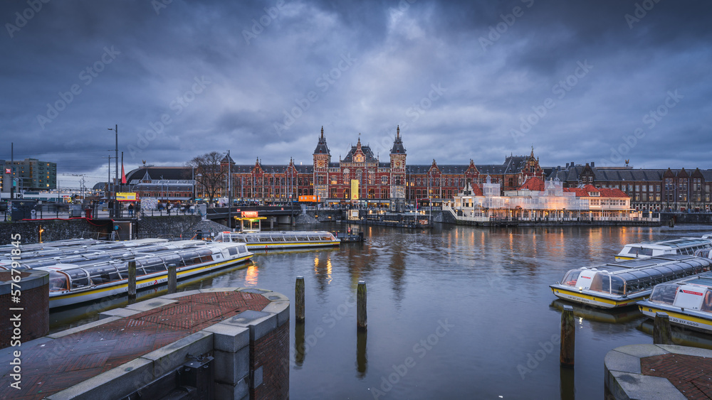 Amsterdam Centraal and canal landscape at dusk