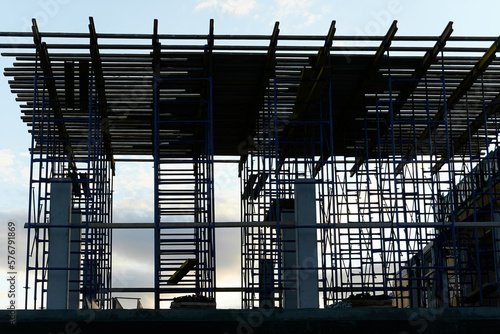 silhouette of building concrete structures with rebar against the background of the sunset sky. background. blank for the designer. for an article about construction or building infrastructure