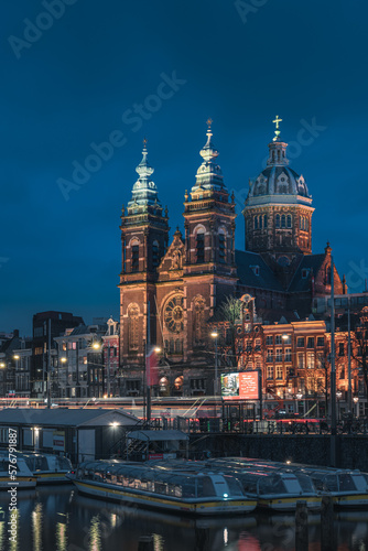 Basilica of Saint Nicholas and canal landscape at night, Amsterdam, Netherlands
