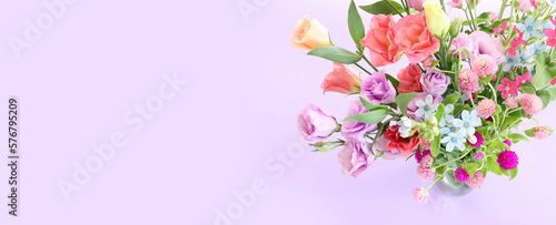 Top view image of pink and purple flowers composition over pastel background