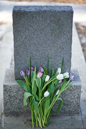 Flowers for the dearly departed. Shot of a gravestone in a cemetery.