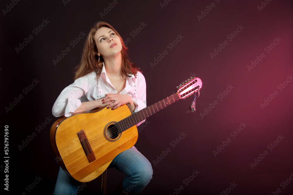 Attractive model, Girl, woman dreams with guitar in studio. Attractive model, Girl, woman dreams with guitar in studio.