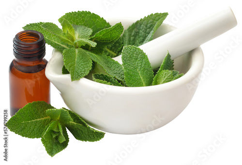 Mint leaves with essential oil in a bottle