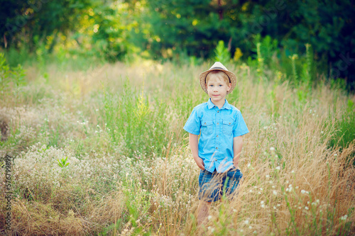 Little boy enjoying life and nature. Happy Kid on summer field . Fresh air, environment concept. © lavju83