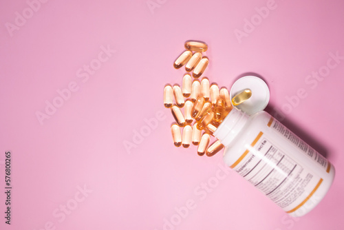 Vitamins Omega 3 6 9 fish oil , vitamin D on a pink background for health lifestyle with copyspace. 