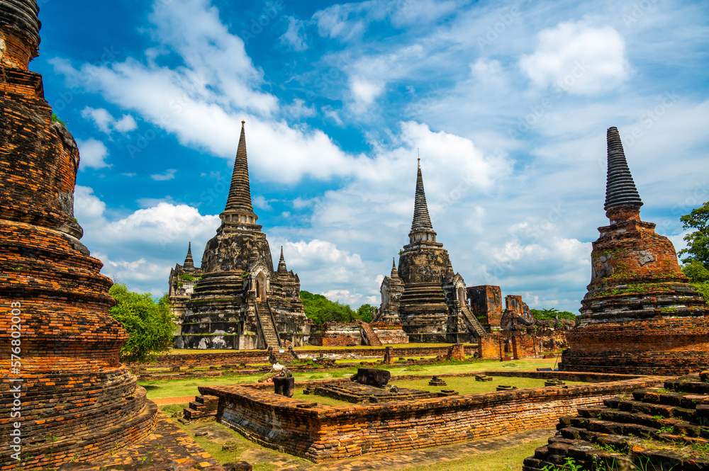 Ruins of ancient city and temples Ayutthaya, Thailand. Old kingdom of Siam. Summer day with blue sky. Famous tourist destination, spiritual place near Bangkok.