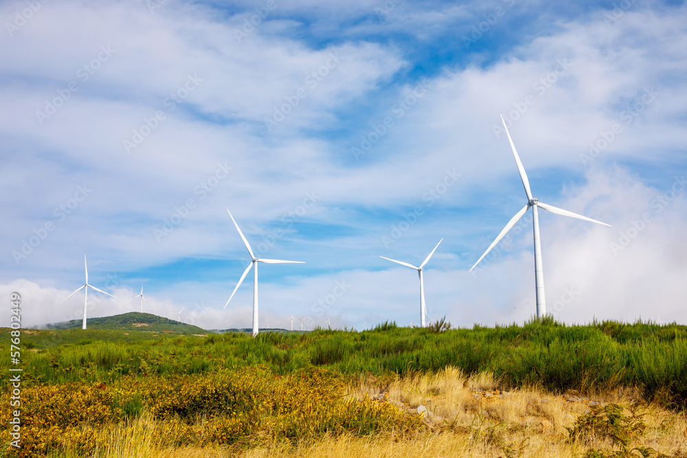 Wind turbines generate electricity in a green meadow. Wind turbines generate electricity in a green meadow.