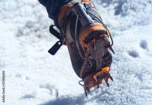 Man is climbing with crampons on the glacier. photo