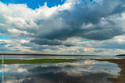 Reflection of white storm clouds in the water of the Tiligul estuary  Ukraine