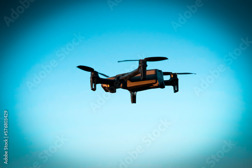 Fototapeta Naklejka Na Ścianę i Meble -  UAV technologies, modern drone is flying in the sky.