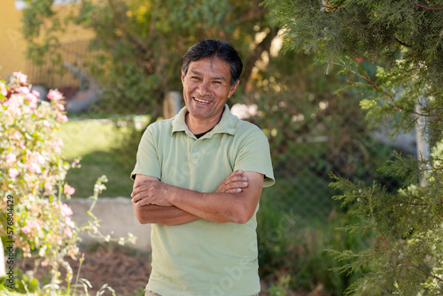 Smiling Latino man outside his house in rural area - Happy Mayan senior - Hispanic proud of his roots