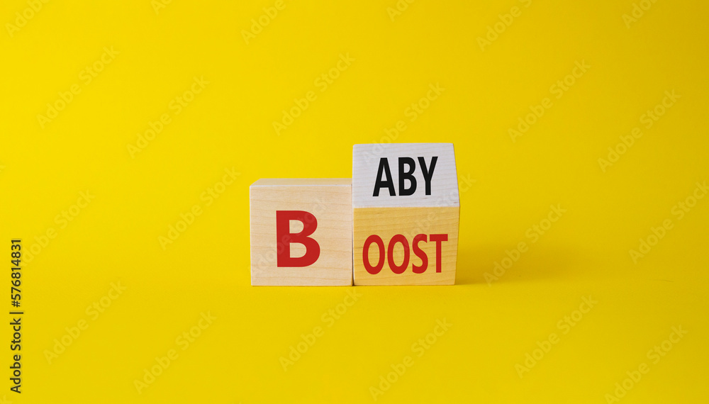 Baby boost symbol. Turned wooden cubes with words Boost and Baby. Beautiful yellow background. Business and baby boost concept. Copy space Baby boost symbol. Turned wooden cubes with words Boost and Baby. Beautiful yellow background. Business and baby boost concept. Copy space