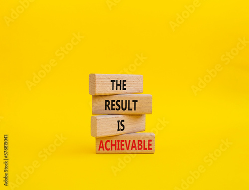 The result is achievable symbol. Concept words The result is achievable on wooden blocks. Beautiful yellow background. Business and The result is achievable concept. Copy space.