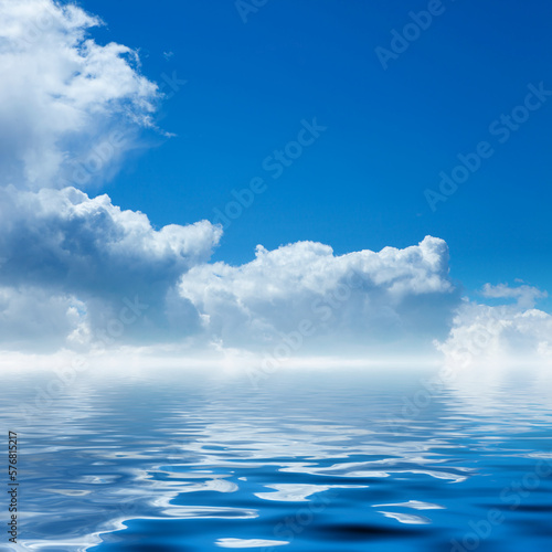 Bright blue sky with clear white clouds. Ocean with sky reflection. Summer background.