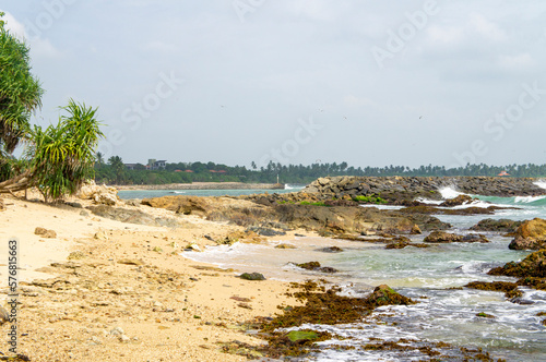 Beautiful tropical landscape. A stone ocean shore with waves and rocks. Beautiful texture background for tourism  design and advertising