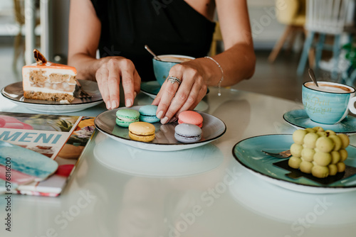 woman details hands drinking coffee eating cakes and macaroons popsi nails inspo aesthetic