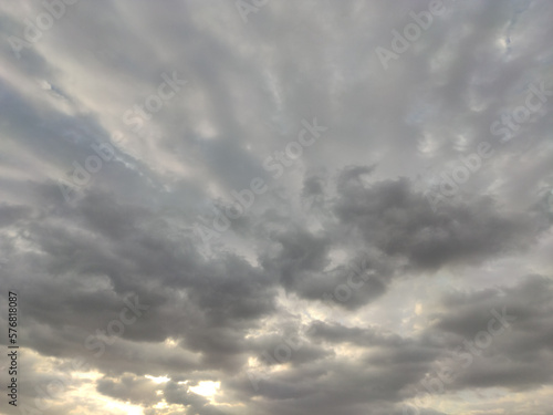 Fototapeta Naklejka Na Ścianę i Meble -  Oddly shaped clouds, cloud in the shape of arms. Sunset