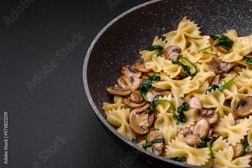 Delicious farfalle pasta with mushrooms, cheese and spinach with spices
