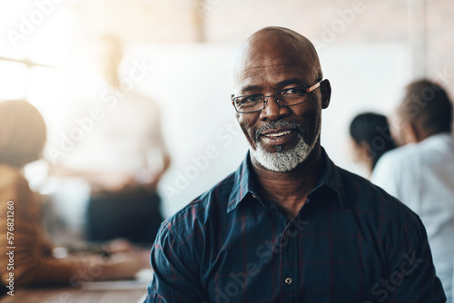 I love what I do thats why Im successful. Cropped portrait of a businessman sitting in the boardroom during a presentation.