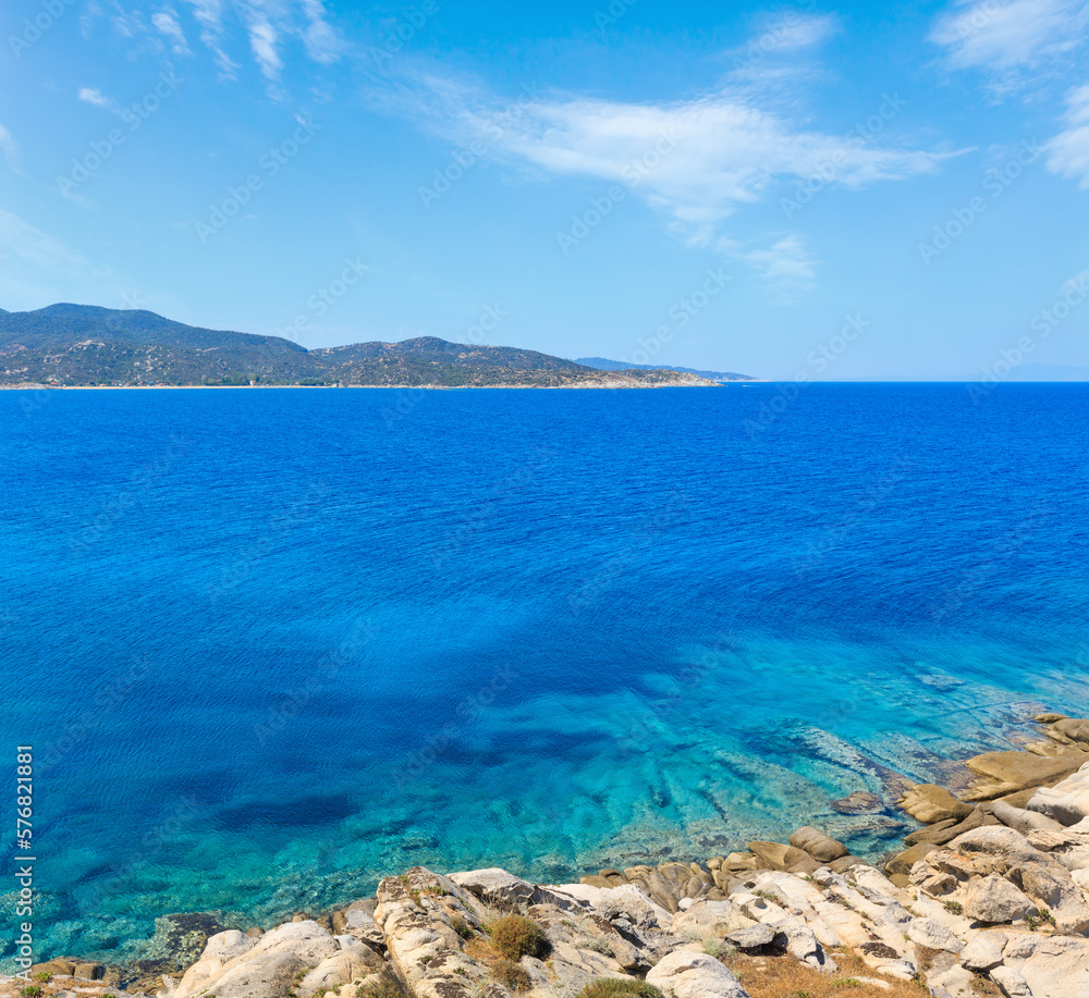 Summer stony Aegean sea coast (Halkidiki, Sithonia, Greece).