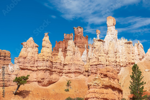 Scenic view of massive steep hoodoo sandstone rock formation with blue background on Peekaboo hiking trail in Bryce Canyon National Park, Utah, USA. Barren desert landscape in natural amphitheatre