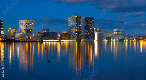 Waterfront city skyline with reflection in the lake at sunset, Almere, Flevoland, Netherlands