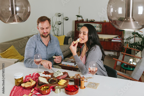 casual couple at home having a dinner with finger food