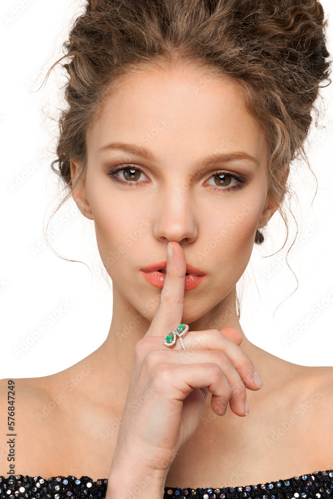 Portrait of beautiful young woman with make-up making a hush gesture Portrait of beautiful young woman with make-up making a hush gesture