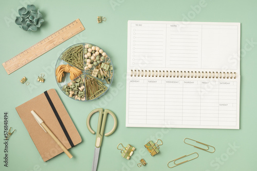 Mockup of  weekly planner and office stationery with copy space for text. Flat lay, top view photo mock up. photo