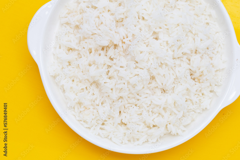 Dish of rice on yellow background.