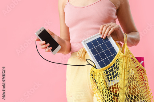 Woman charging mobile phone...