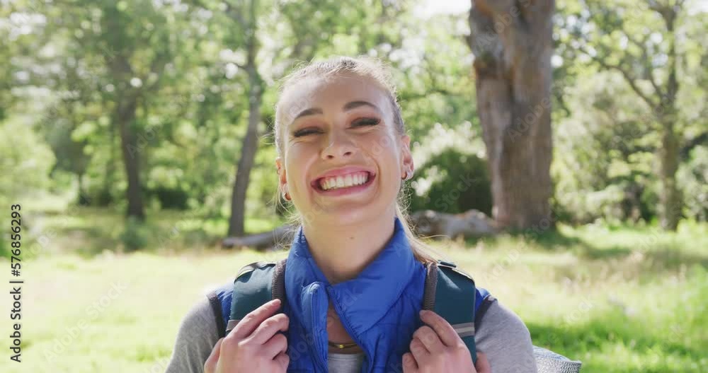Portrait of happy caucasian woman looking at camera in park, slow motion Portrait of happy caucasian woman looking at camera in park, slow motion