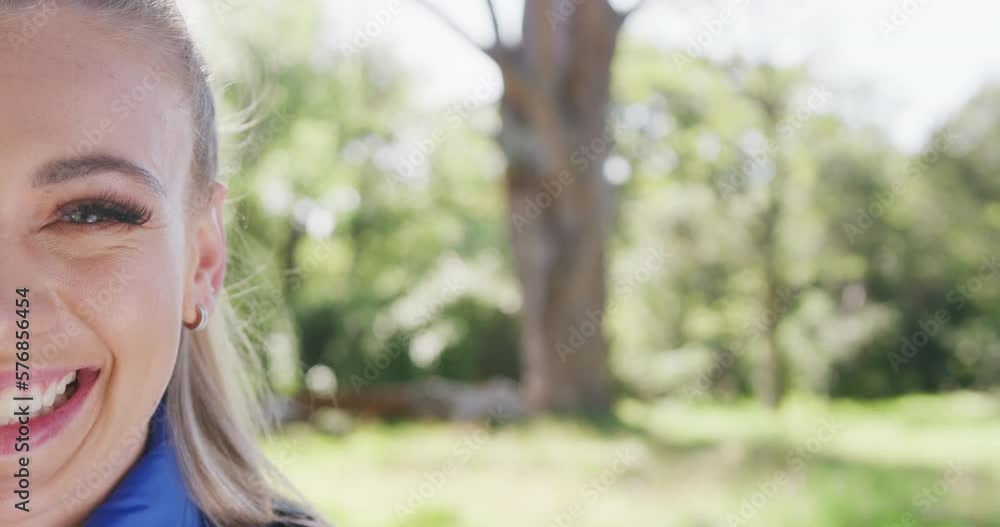 Portrait of happy caucasian woman looking at camera in park, slow motion Portrait of happy caucasian woman looking at camera in park, slow motion