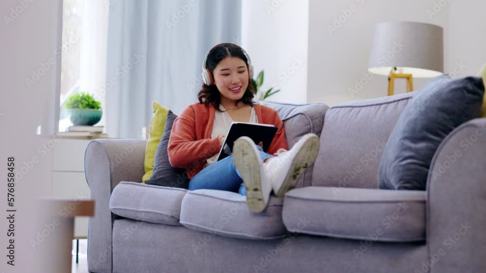 Tablet, headphones and woman relax on couch with music streaming app, social media and watching videos at home. Gen z asian person or young Korea girl on sofa, digital tech and listening to audio Tablet, headphones and woman relax on couch with music streaming app, social media and watching videos at home. Gen z asian person or young Korea girl on sofa, digital tech and listening to audio